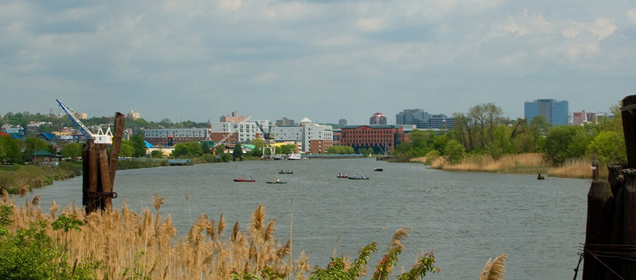 Wide view of the Christina River with city buildings in the distance.