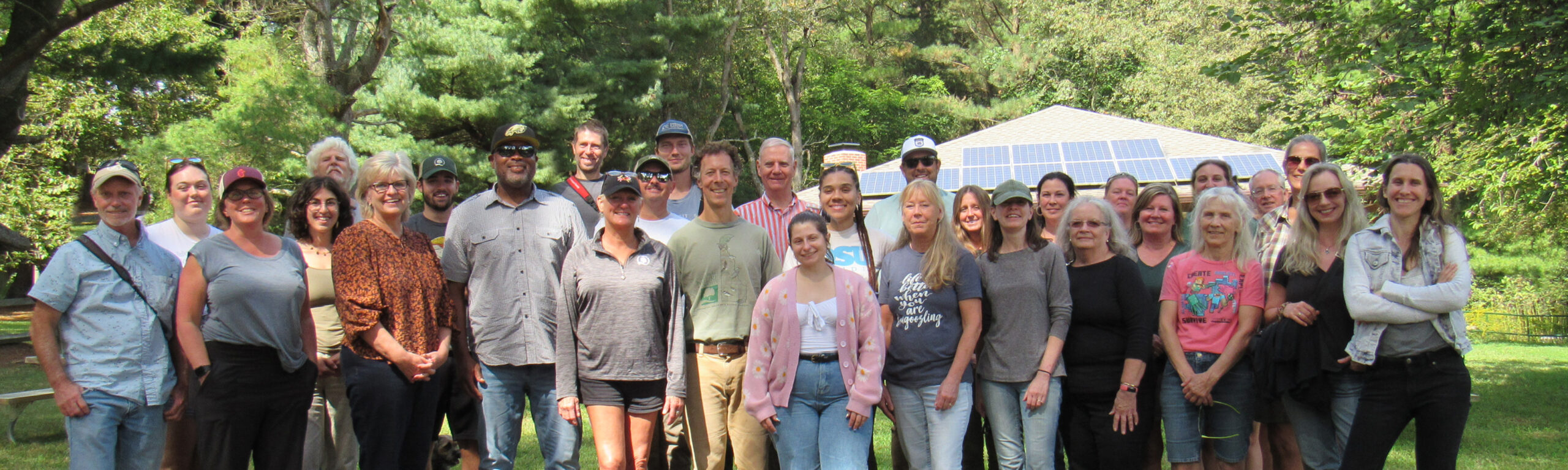 Group of people standing together outdoors at a nature center.