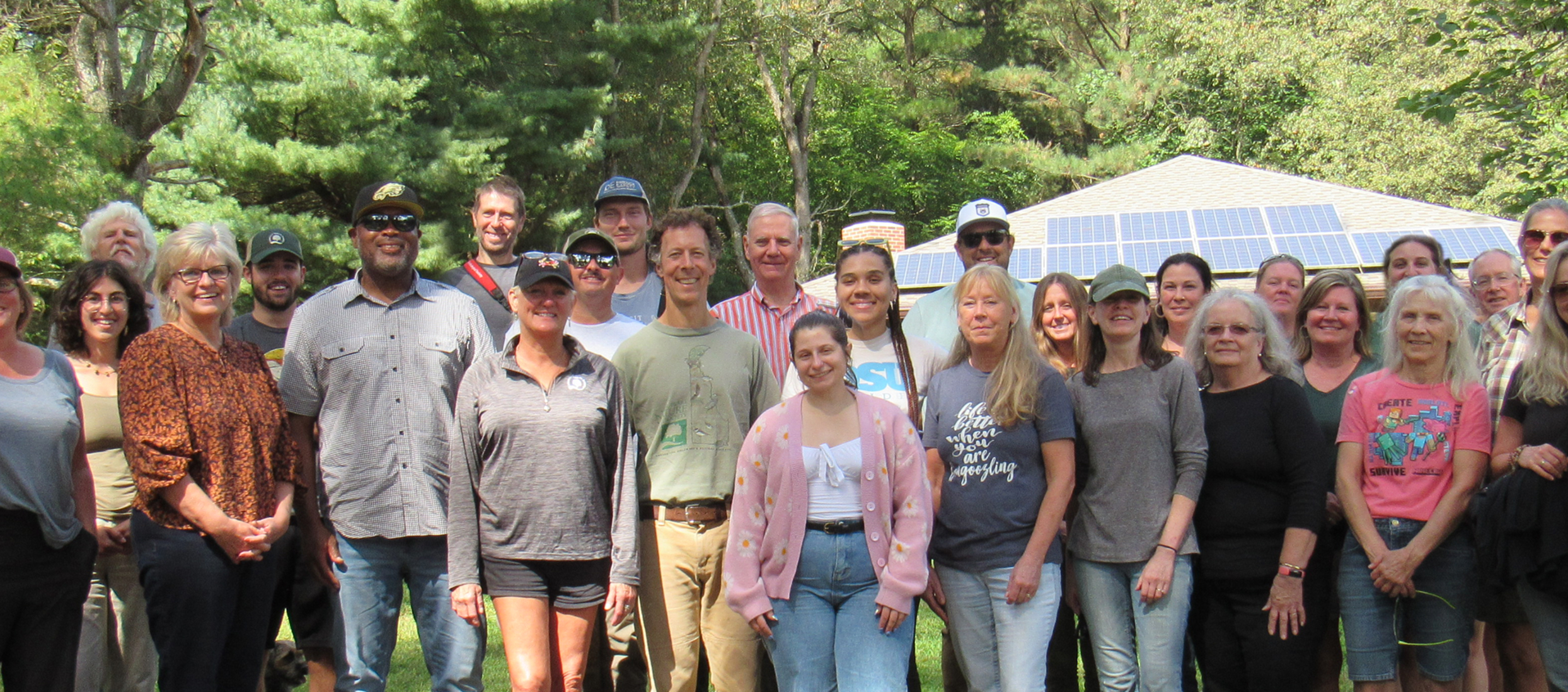 Group of people standing together outdoors.